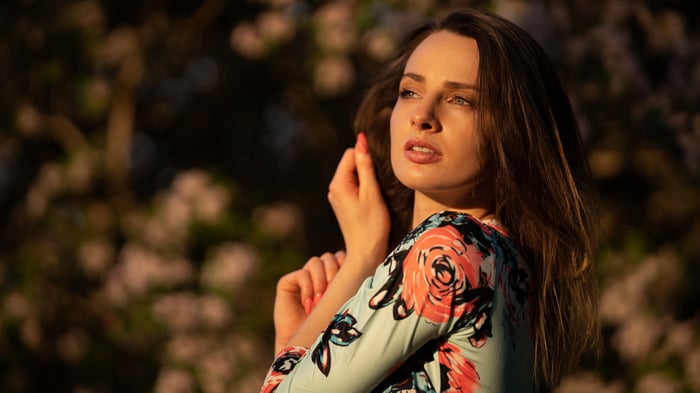 Girl in floral dress with sun rays on face