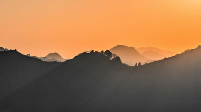 Sunset over a misty mountain range