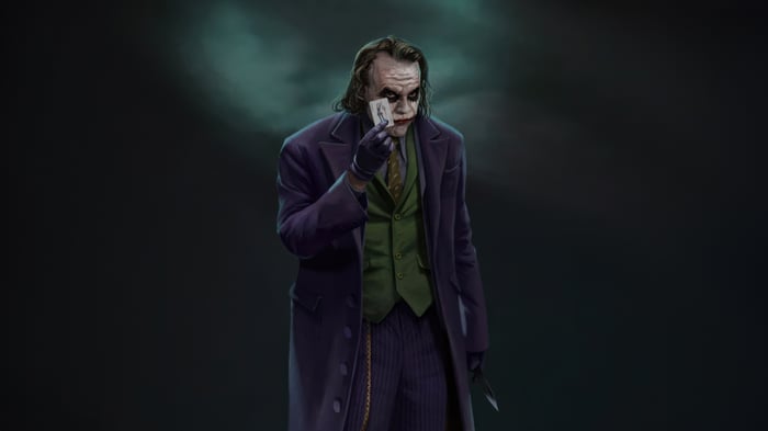 The Joker holding a playing card