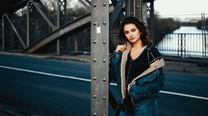 Girl leaning on a bridge structure