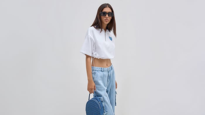 Girl in white top and blue jeans with backpack