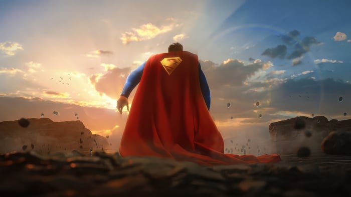 Superman stands on rocky terrain at sunset