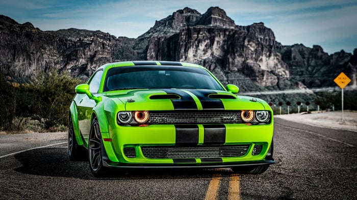 Glossy Green Dodge Challenger on a Mountain Road