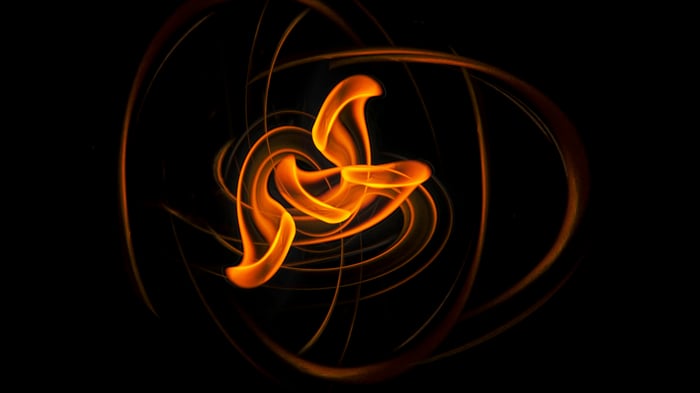 Abstract orange light trails forming a core shape