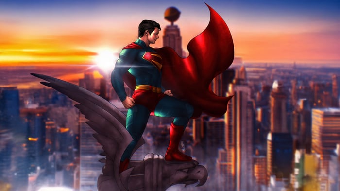 Superman standing on a gargoyle overlooking a city at sunset