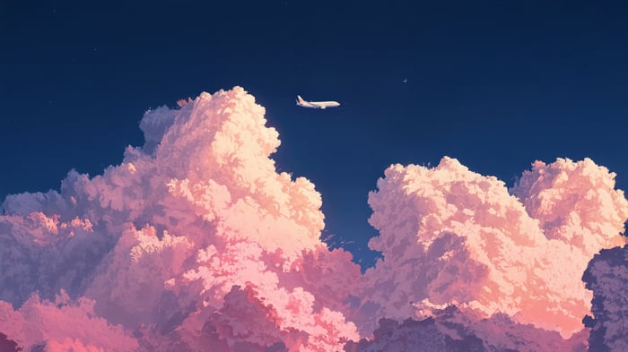 Airplane flying through pink clouds at night
