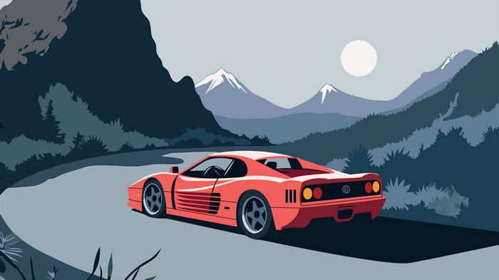 Red Sports Car Driving on a Winding Mountain Road