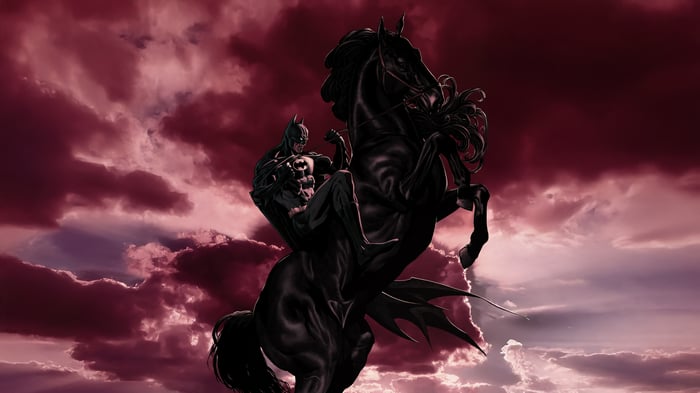Batman on a black horse against a red sky