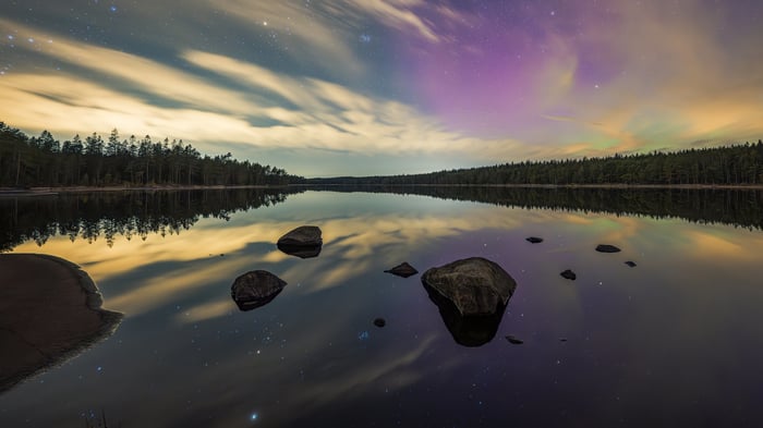 Aurora Borealis Over a Reflective Lake with Stars