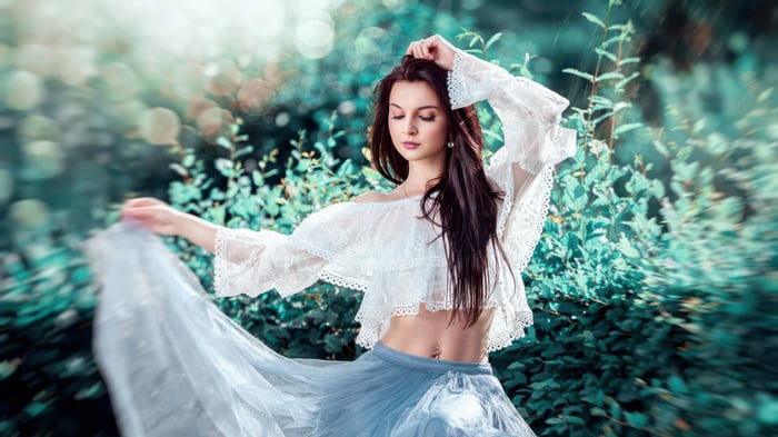 Woman in a white lace top and blue skirt