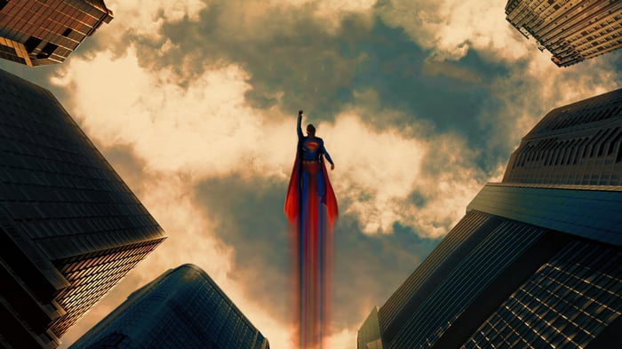 Superman flying upwards between skyscrapers