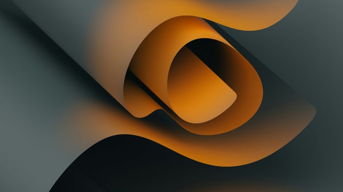 Orange and black folded paper swirl abstract