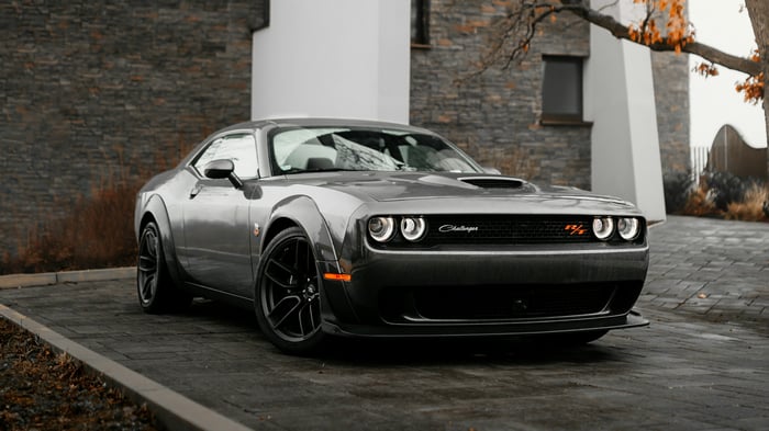 Gray Dodge Challenger R/T parked in front of a modern house