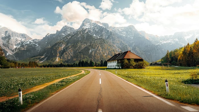 Road to Almsee in Austria with mountains and house