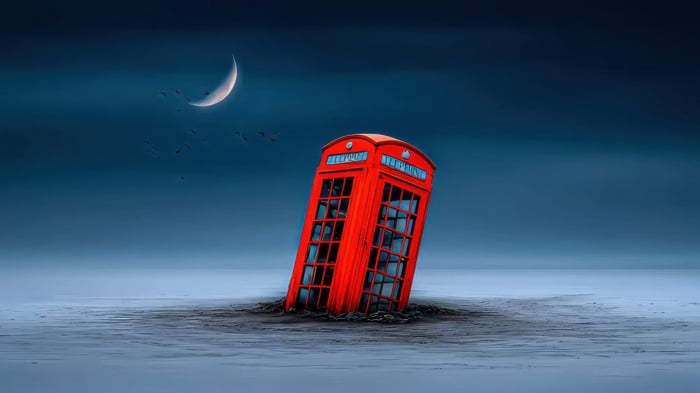 Red Phone Booth Sinking in the Ocean Under a Crescent Moon