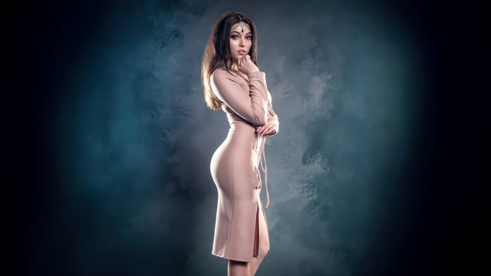 Woman in a rose tone dress with headpiece
