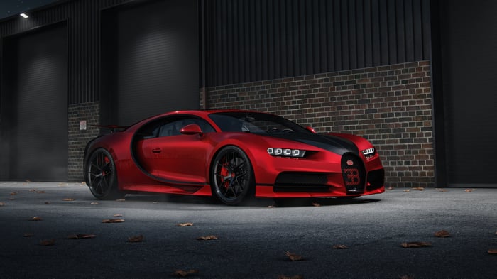 Red Bugatti Chiron parked in front of a garage