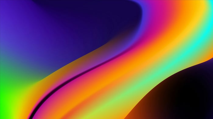 Abstract gradient of purple, green, orange, and blue