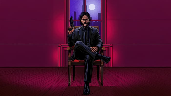 John Wick sits with a gun