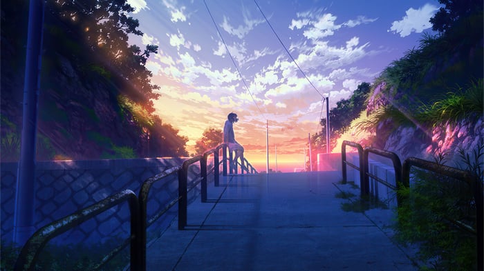 Person sitting on stairs at sunset