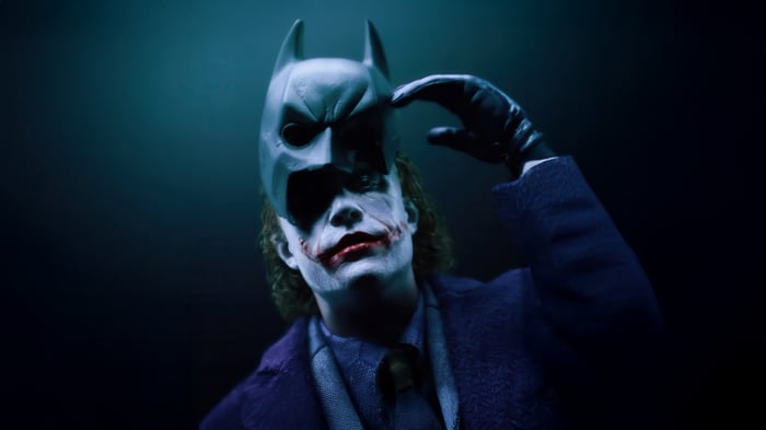 Joker removing Batman mask