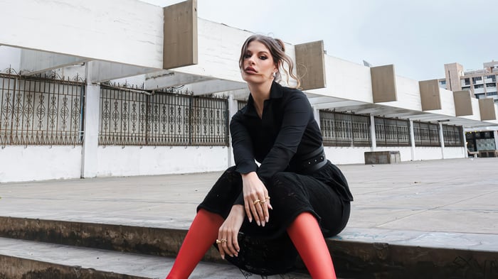 Woman in black dress and red hosiery