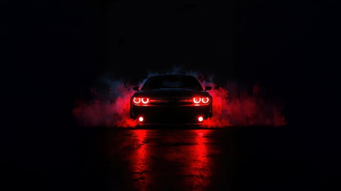 Dark Dodge Challenger with red lights and smoke
