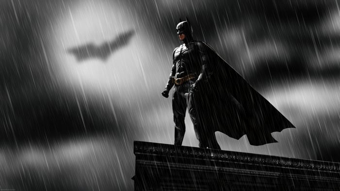 Batman on a rooftop in the rain