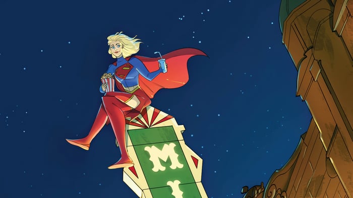 Supergirl Sitting on a Sign with Popcorn and Drink