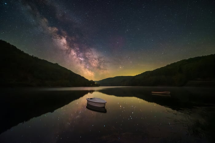 Milky Way Reflection on Mountain Lake with Boats
