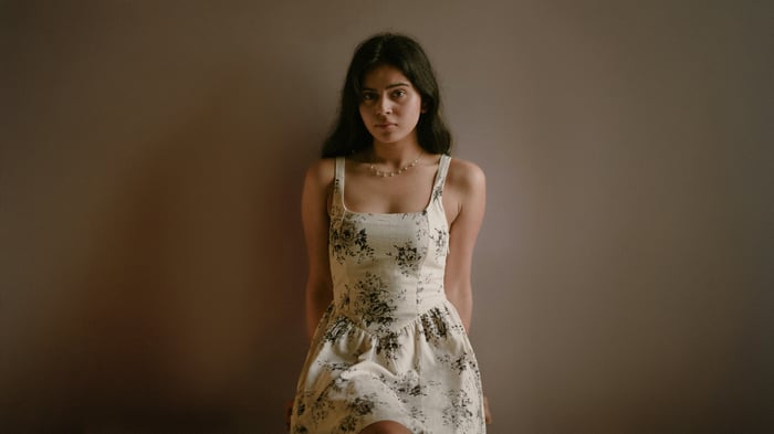 Girl in a floral dress looking at the viewer