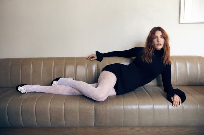 Sophie Nelisse on a leather couch