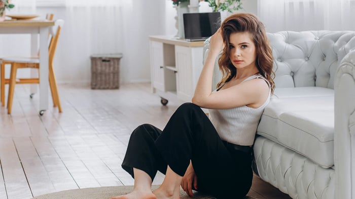 Girl Relaxing On White Living Room Floor