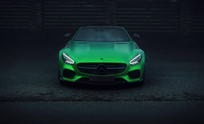 Green Mercedes-AMG GT R parked on wet asphalt