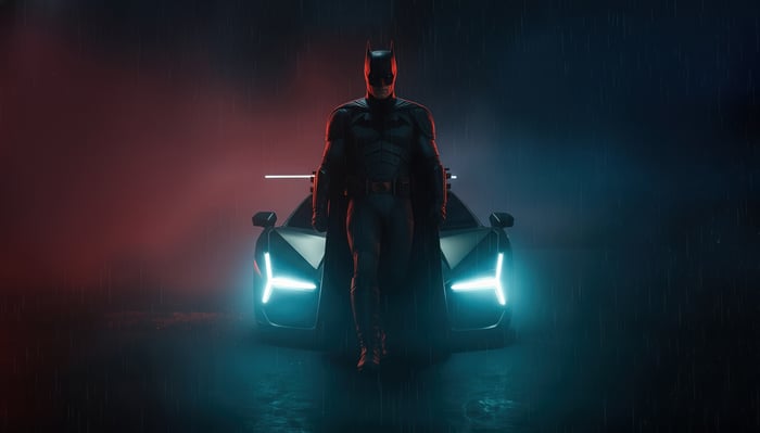 Batman and his Batmobile in the rain