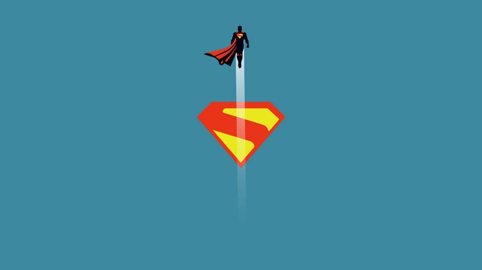 Superman flying above the S-shield logo