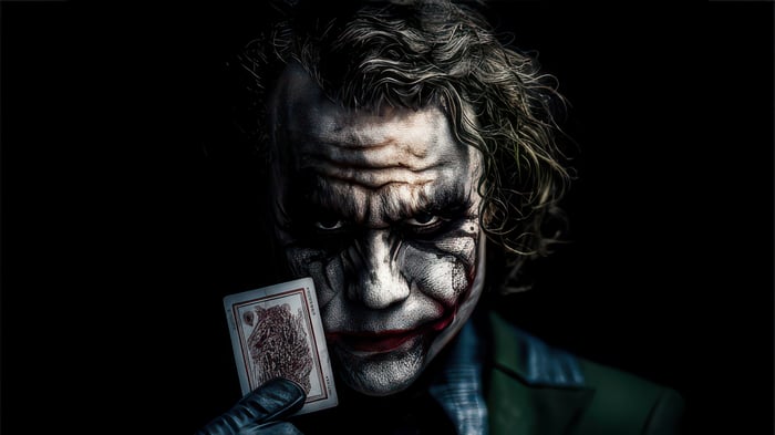 The Joker holding a playing card