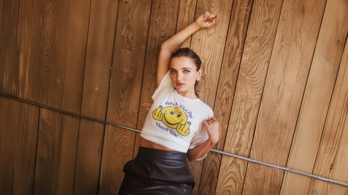Madeleine McGraw in white t-shirt and black skirt