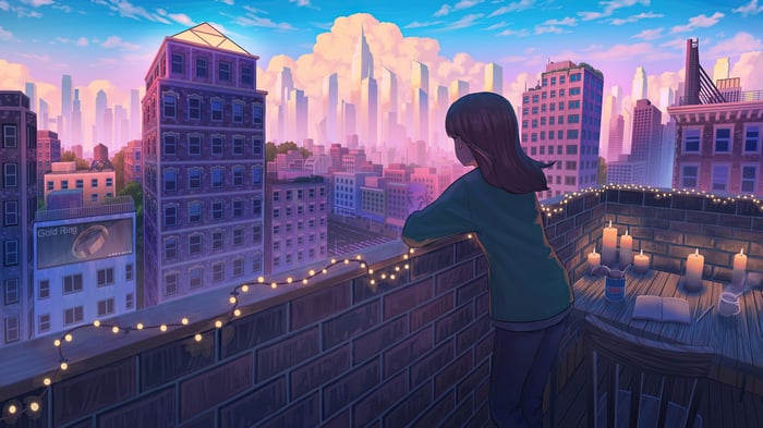 Girl on a rooftop overlooking a city at sunset
