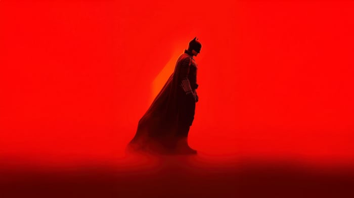 Batman in silhouette against a red background