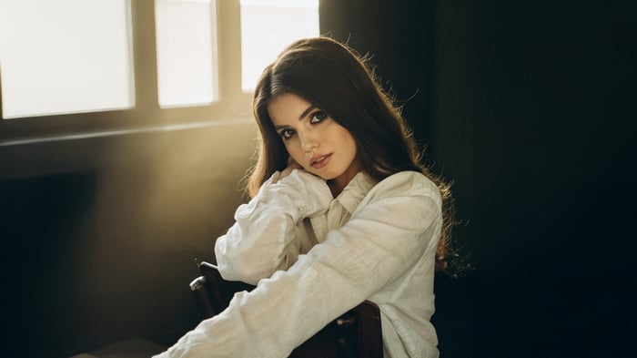 Young woman in a white shirt looking at the viewer