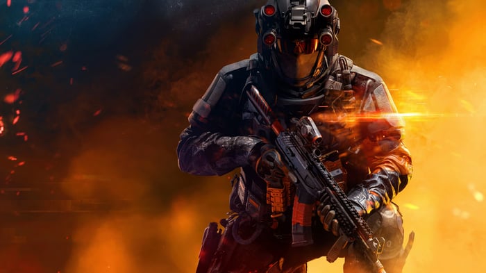 Soldier with rifle in fiery battlefield
