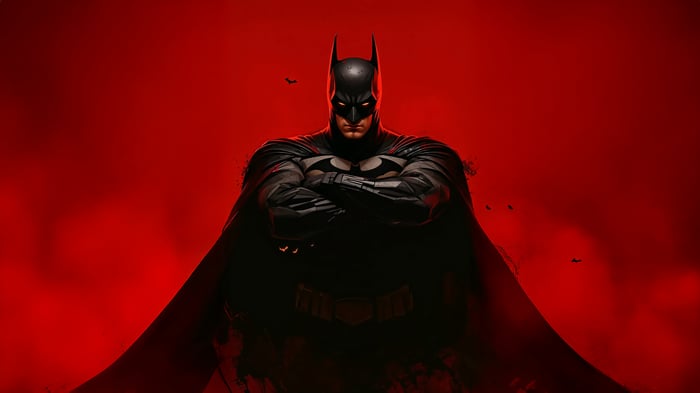 Batman with arms crossed on red background