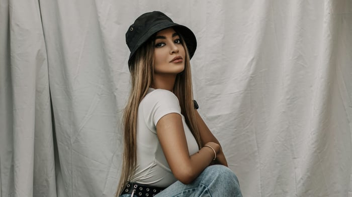 Woman in bucket hat and white shirt