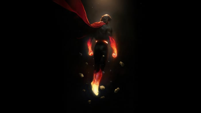 Superman flying with fiery hands and feet