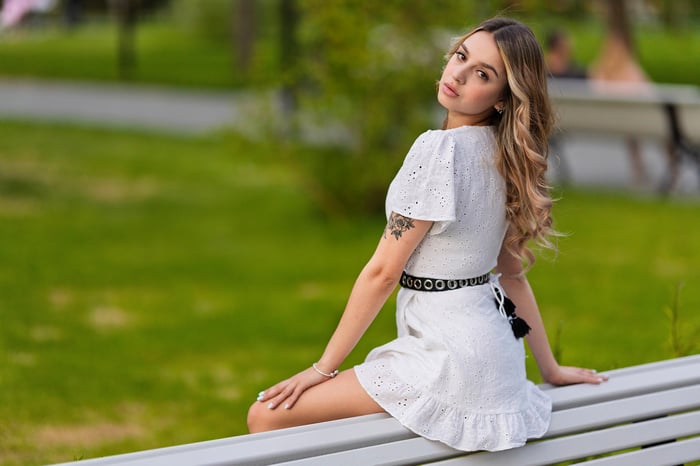 Girl Sitting on a Bench in a Park