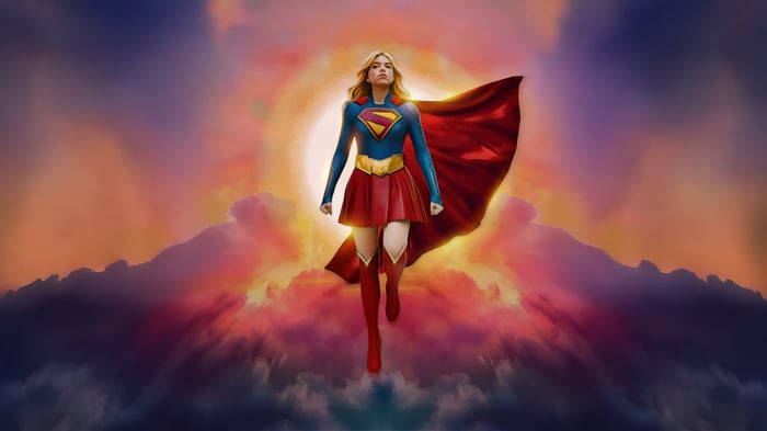 Supergirl flying against a sunset