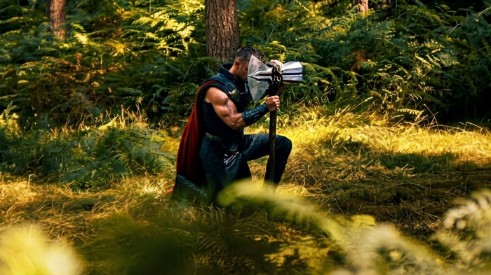 Thor with Stormbreaker in a forest