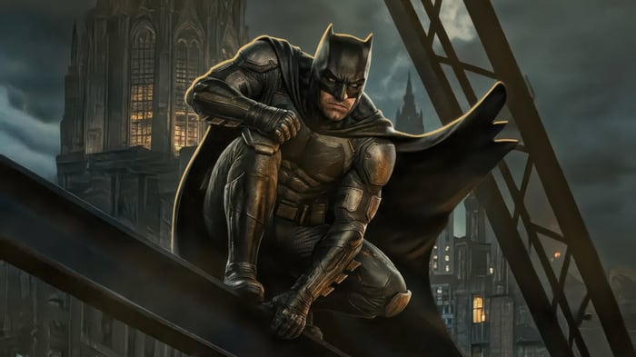 Batman crouches on a metal beam overlooking a city