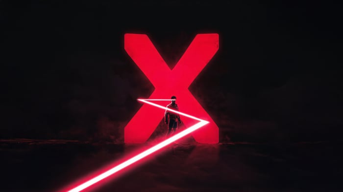 Man standing in front of a giant red X with laser beams